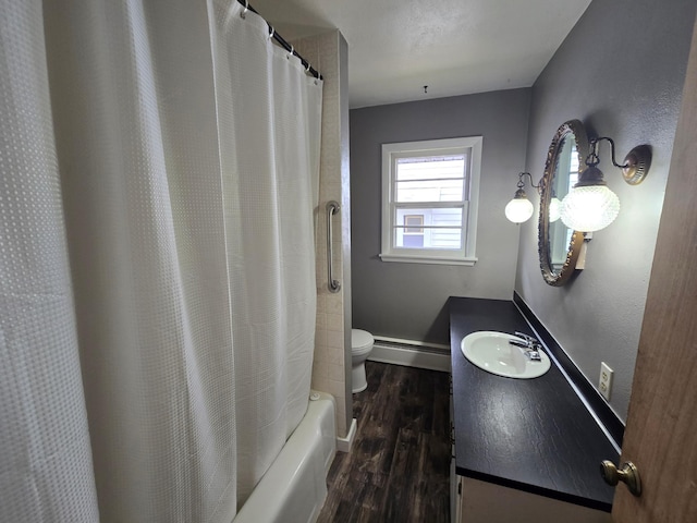 full bathroom featuring hardwood / wood-style floors, vanity, shower / bath combo, a baseboard heating unit, and toilet