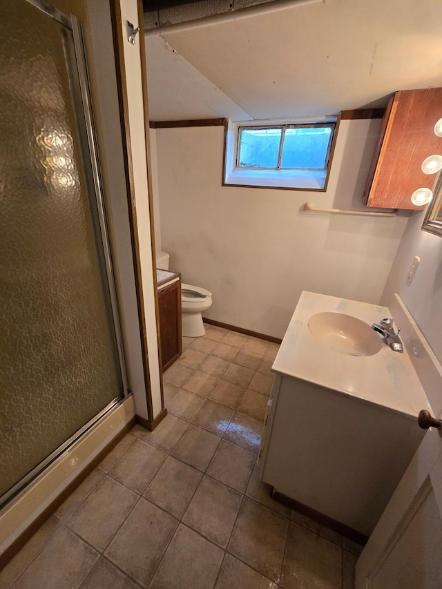 bathroom featuring tile patterned flooring, an enclosed shower, vanity, and toilet