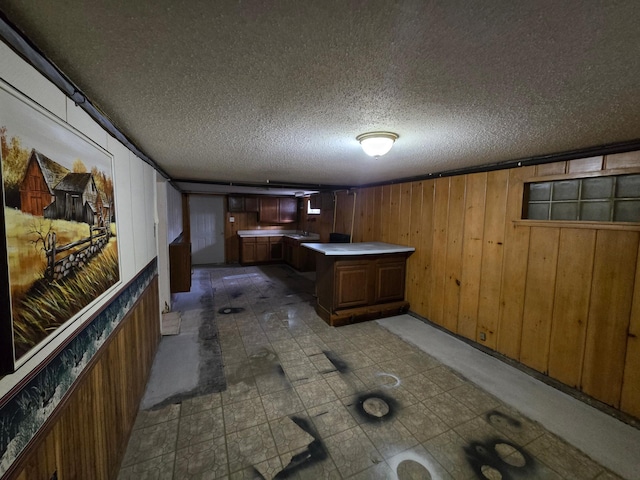 bar with wood walls and a textured ceiling