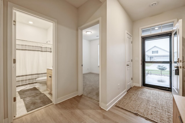 entryway with light hardwood / wood-style floors