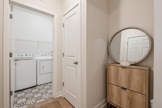 washroom with independent washer and dryer and light hardwood / wood-style floors