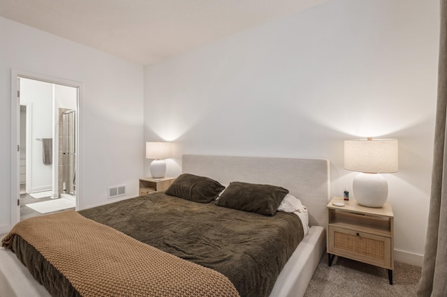 bedroom featuring ensuite bathroom and light carpet