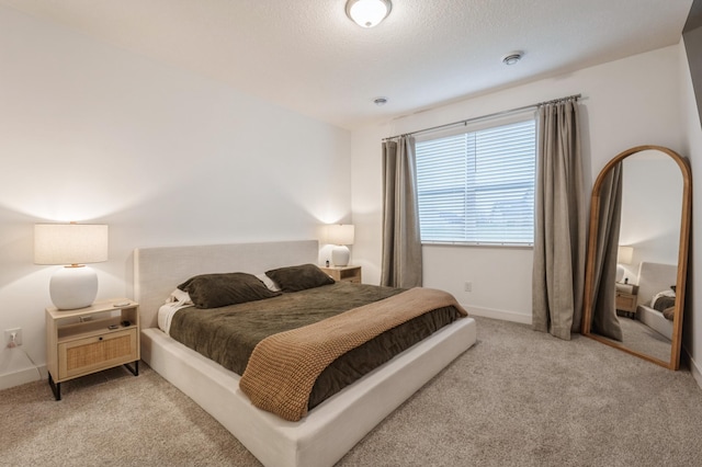 carpeted bedroom with a textured ceiling