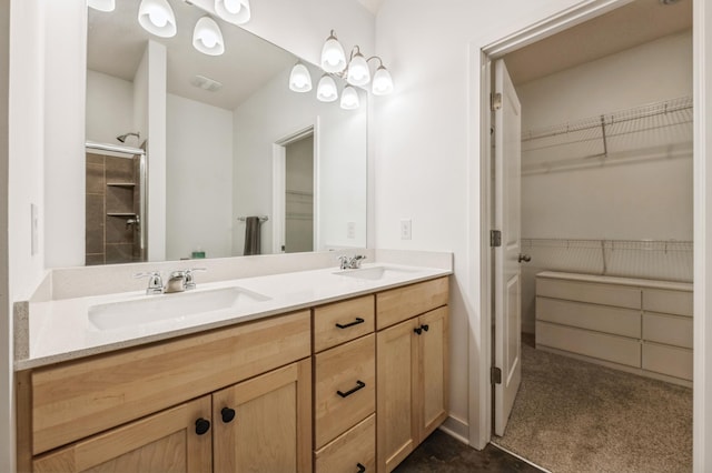 bathroom with walk in shower and vanity