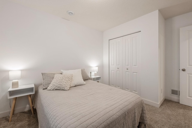 carpeted bedroom with a closet