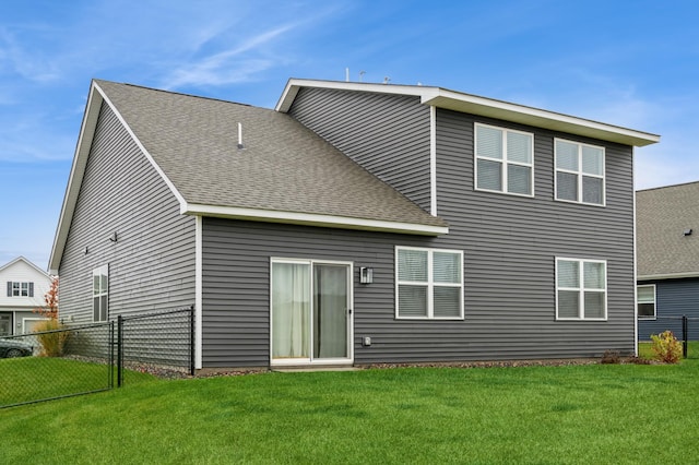 rear view of house with a lawn