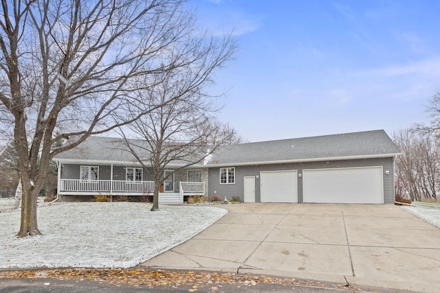 view of front facade featuring a porch, a garage, and driveway