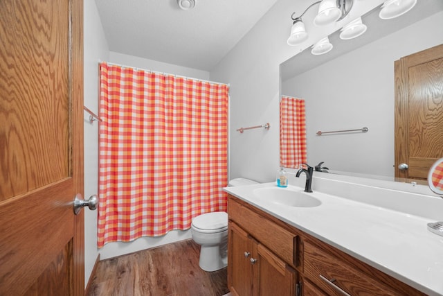 full bathroom with shower / bath combo with shower curtain, toilet, wood finished floors, and vanity