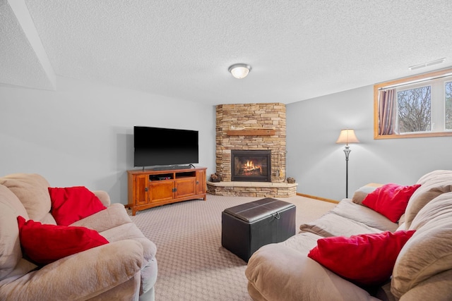 living area with baseboards, light carpet, a textured ceiling, and a stone fireplace