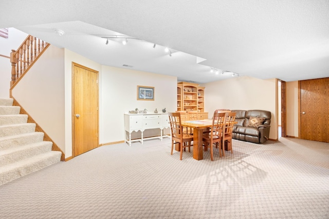 dining room featuring visible vents, baseboards, stairs, carpet floors, and a textured ceiling