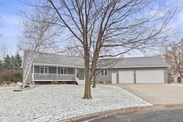 single story home with driveway, a porch, and an attached garage