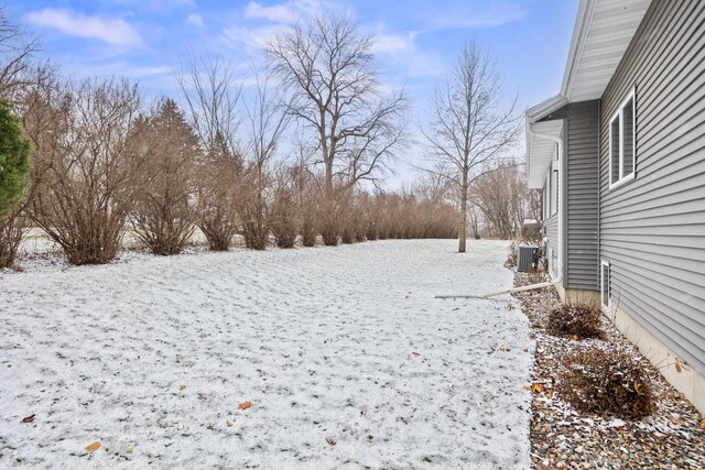 yard layered in snow with central air condition unit