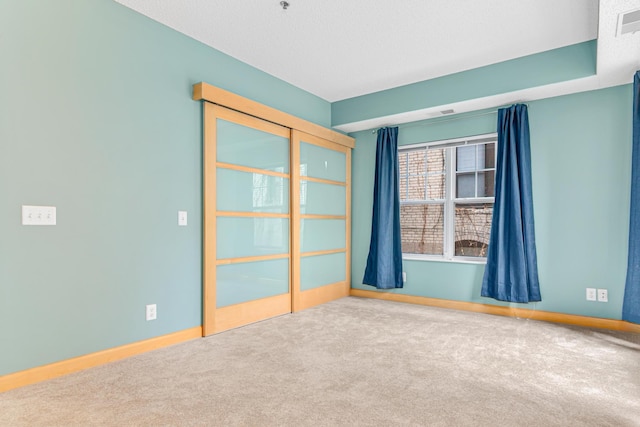 empty room featuring carpet flooring and a textured ceiling