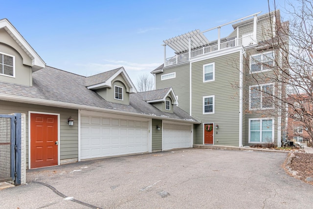 view of front of home featuring a garage and a balcony