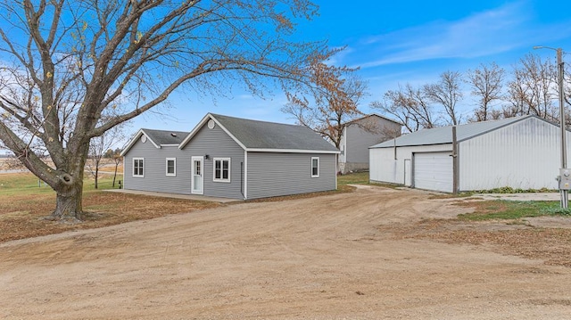 view of property exterior with an outbuilding and a garage