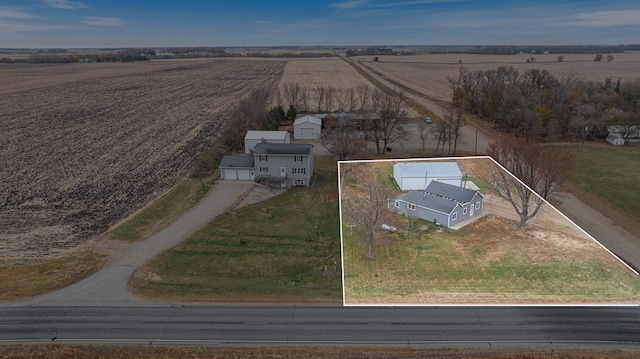 birds eye view of property with a rural view