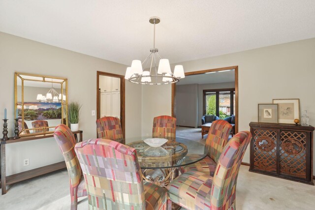 dining space featuring light carpet, baseboards, and an inviting chandelier