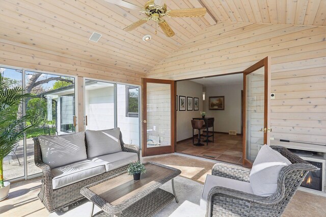 living area with wood ceiling, high vaulted ceiling, wood walls, and a sunroom