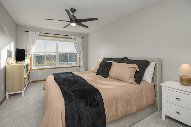 bedroom featuring light colored carpet and ceiling fan