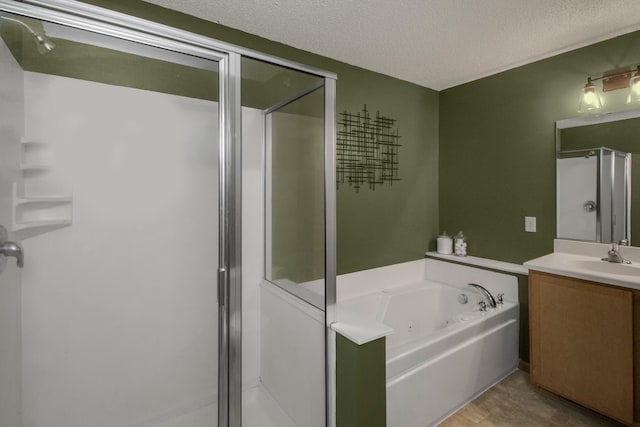 bathroom featuring separate shower and tub, vanity, and a textured ceiling