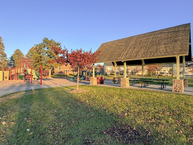 view of property's community with a yard and a playground