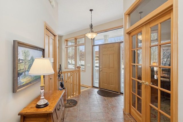 foyer entrance featuring french doors and light tile patterned floors