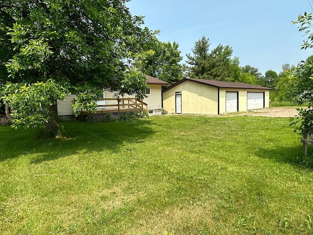 view of yard featuring an outbuilding and a garage