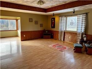 sitting room featuring beamed ceiling and light hardwood / wood-style flooring