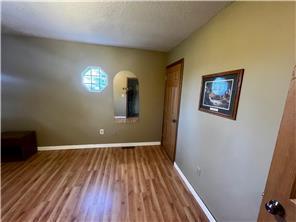 unfurnished bedroom with wood-type flooring