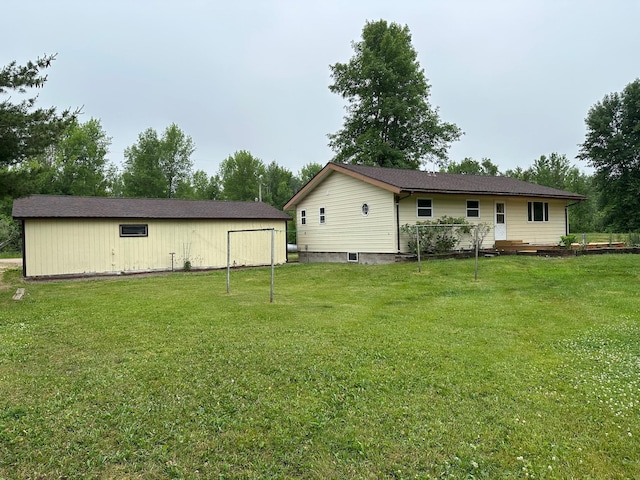 rear view of property featuring a lawn and a deck