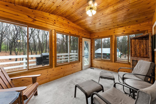 sunroom featuring wood ceiling, ceiling fan, and lofted ceiling