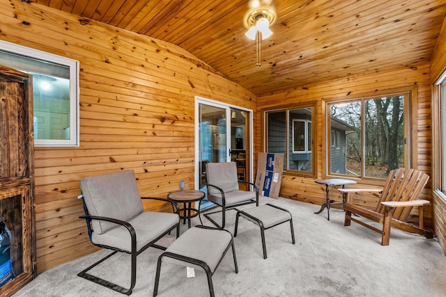 sunroom featuring wood ceiling, ceiling fan, and vaulted ceiling