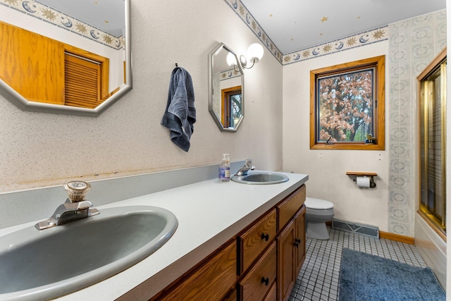 full bathroom featuring vanity, tile patterned floors, shower / bath combination with glass door, and toilet