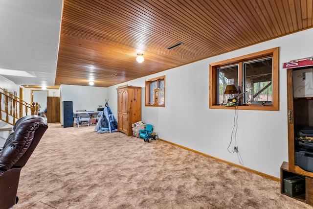 interior space featuring wood ceiling and carpet floors