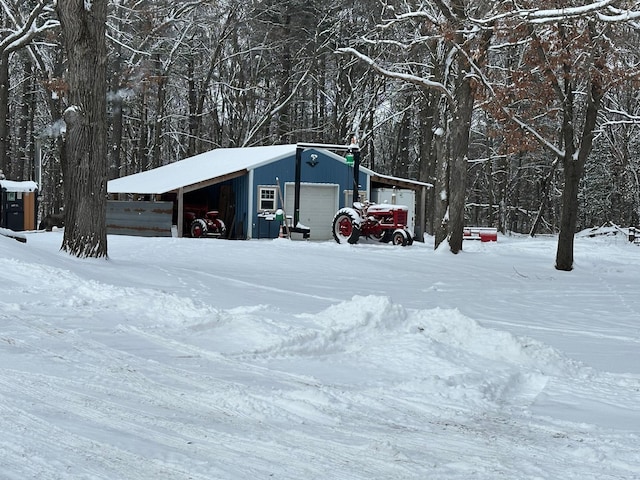 exterior space featuring a garage and an outbuilding