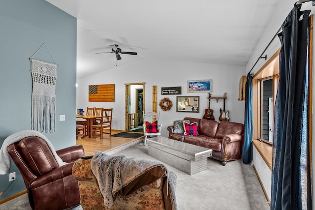 carpeted living room with ceiling fan and vaulted ceiling