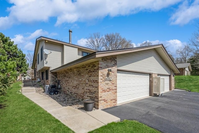 4167 Pepperwood Trl, Minnetonka, MN 55305 - view of property exterior with brick siding, an attached garage, asphalt driveway, and a lawn