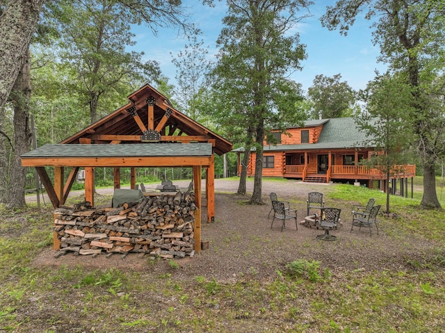 view of yard featuring a deck and an outdoor fire pit