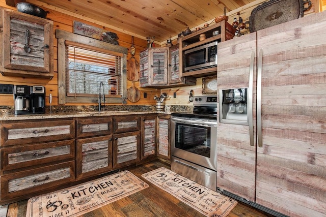 kitchen featuring stainless steel appliances, sink, dark hardwood / wood-style floors, dark stone countertops, and wood ceiling