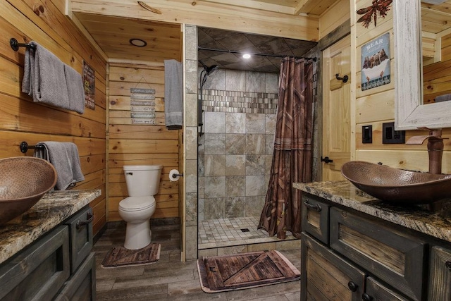 bathroom with a shower with curtain, vanity, and wooden walls