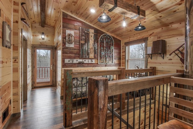 interior space with wood walls, dark hardwood / wood-style floors, vaulted ceiling, and wooden ceiling