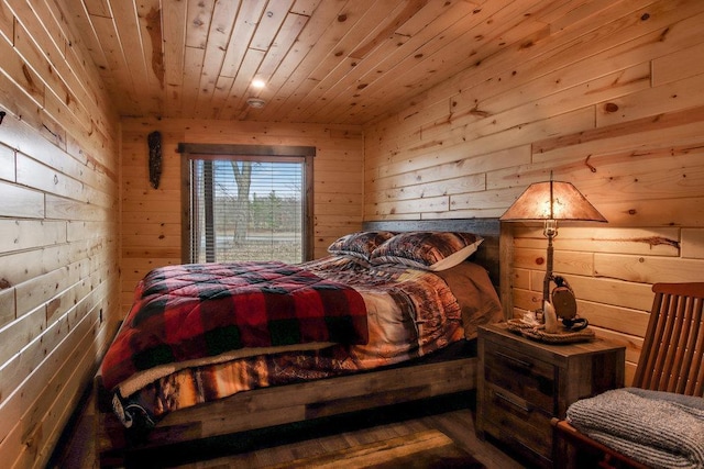 bedroom with wood walls and wooden ceiling