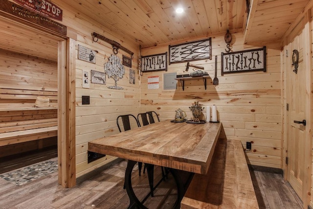 dining area featuring wooden walls, hardwood / wood-style flooring, and wooden ceiling