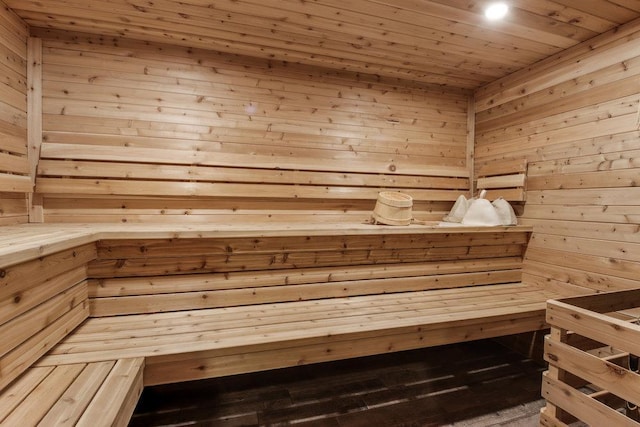 view of sauna with wood walls, hardwood / wood-style flooring, and wood ceiling