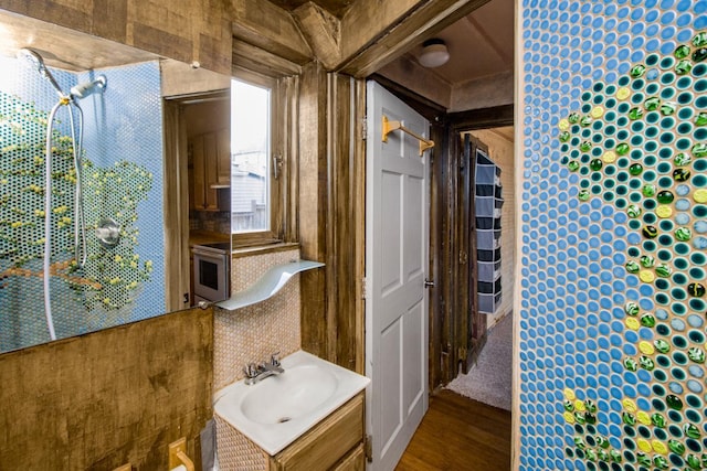 bathroom with wood finished floors and vanity