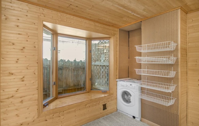 laundry area featuring laundry area, wood ceiling, wooden walls, and washer / clothes dryer