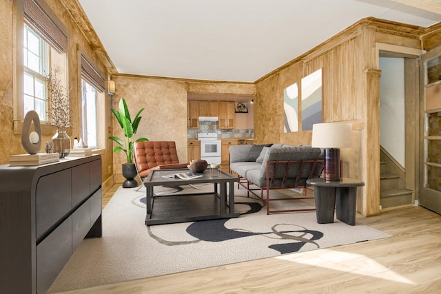 living area with stairs and light wood-style floors