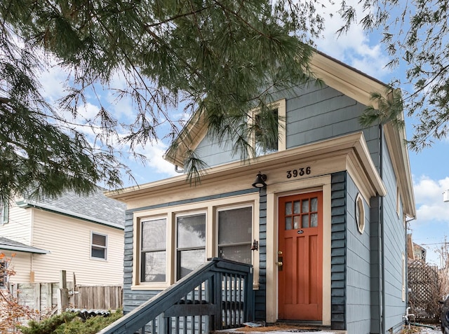 doorway to property featuring fence