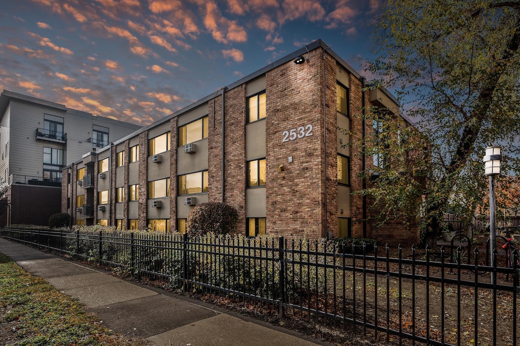 view of outdoor building at dusk