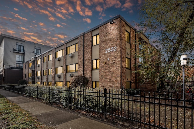 view of outdoor building at dusk